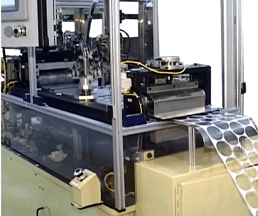 Cap lining machine feeding liner discs punched from a roll of material