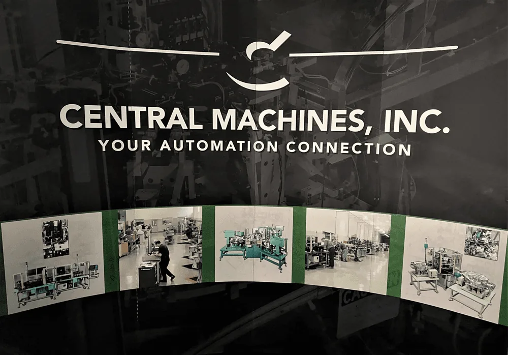Central Machines, Inc. exhibit backdrop with the logo and photos of machines