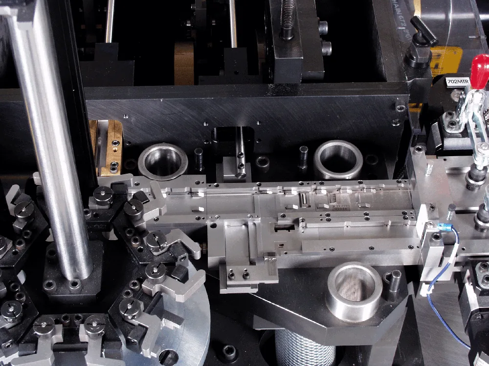 Close-up of machined clamping fixtures on a connector assembly machine
