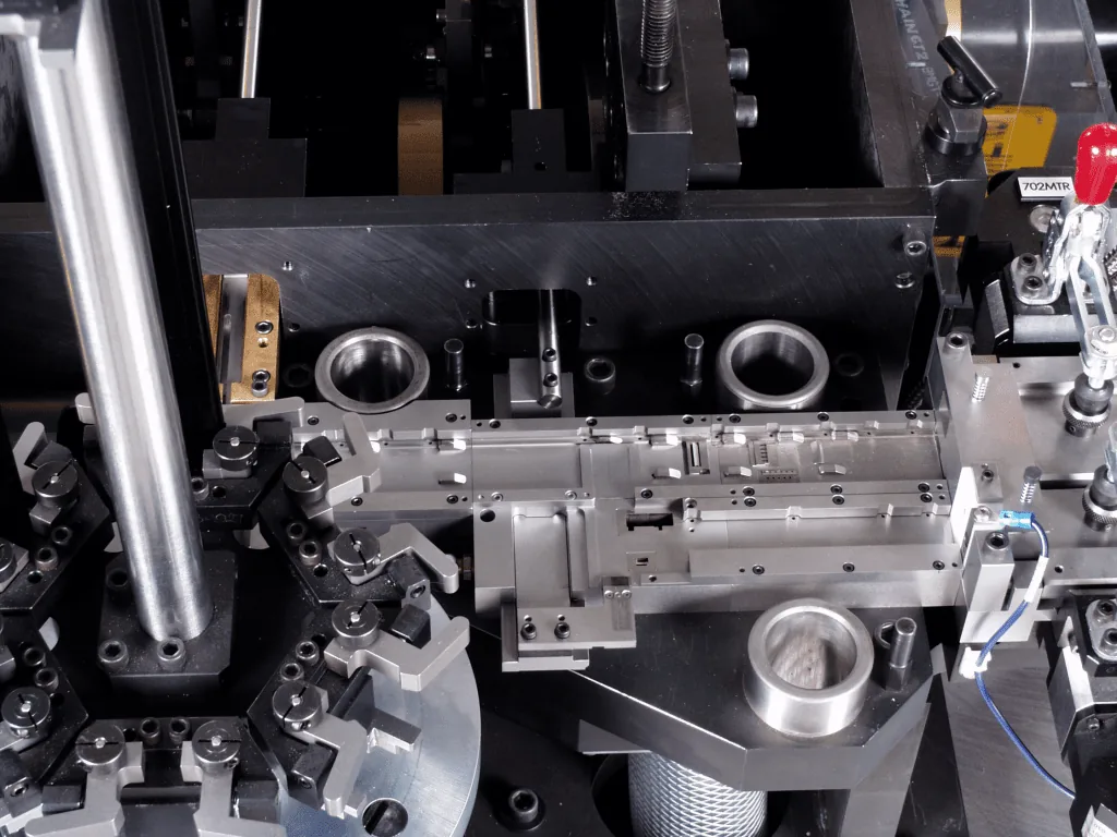 Close-up of machined clamping fixtures on a connector assembly machine