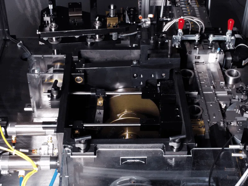 Close-up of the tooling plate and clamps on a connector assembly machine