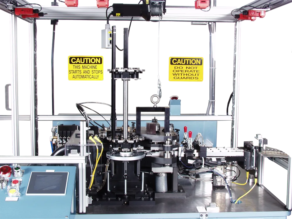 Connector assembly machine with caution signs and a rotary tooling station