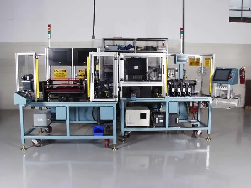 Custom automation machine on a clean shop floor with monitors and a touchscreen