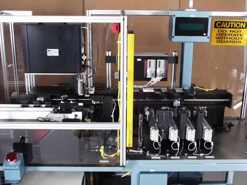 Custom automation machine with servo drives and a caution sign